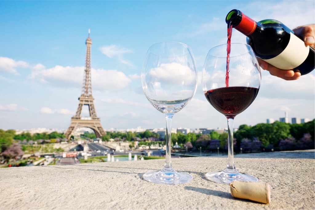 two-glasses-and-bottle-of-red-wine-at-eiffel-tower-picture-id170610563.jpg
